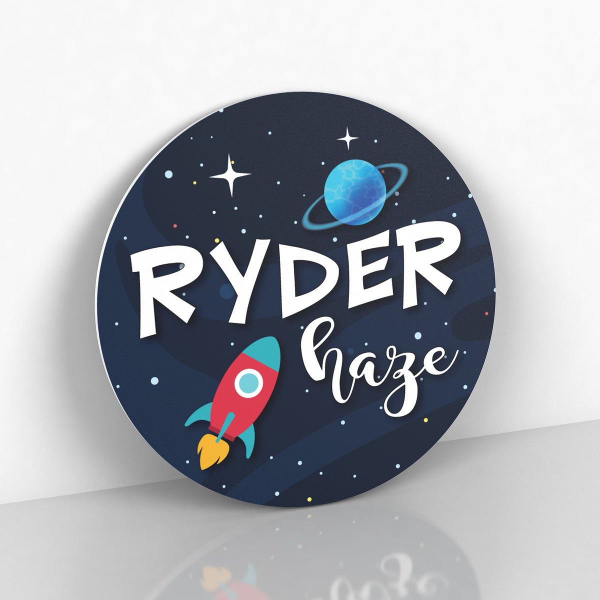 round name sign with navy blue background, starts, spaceship and planets