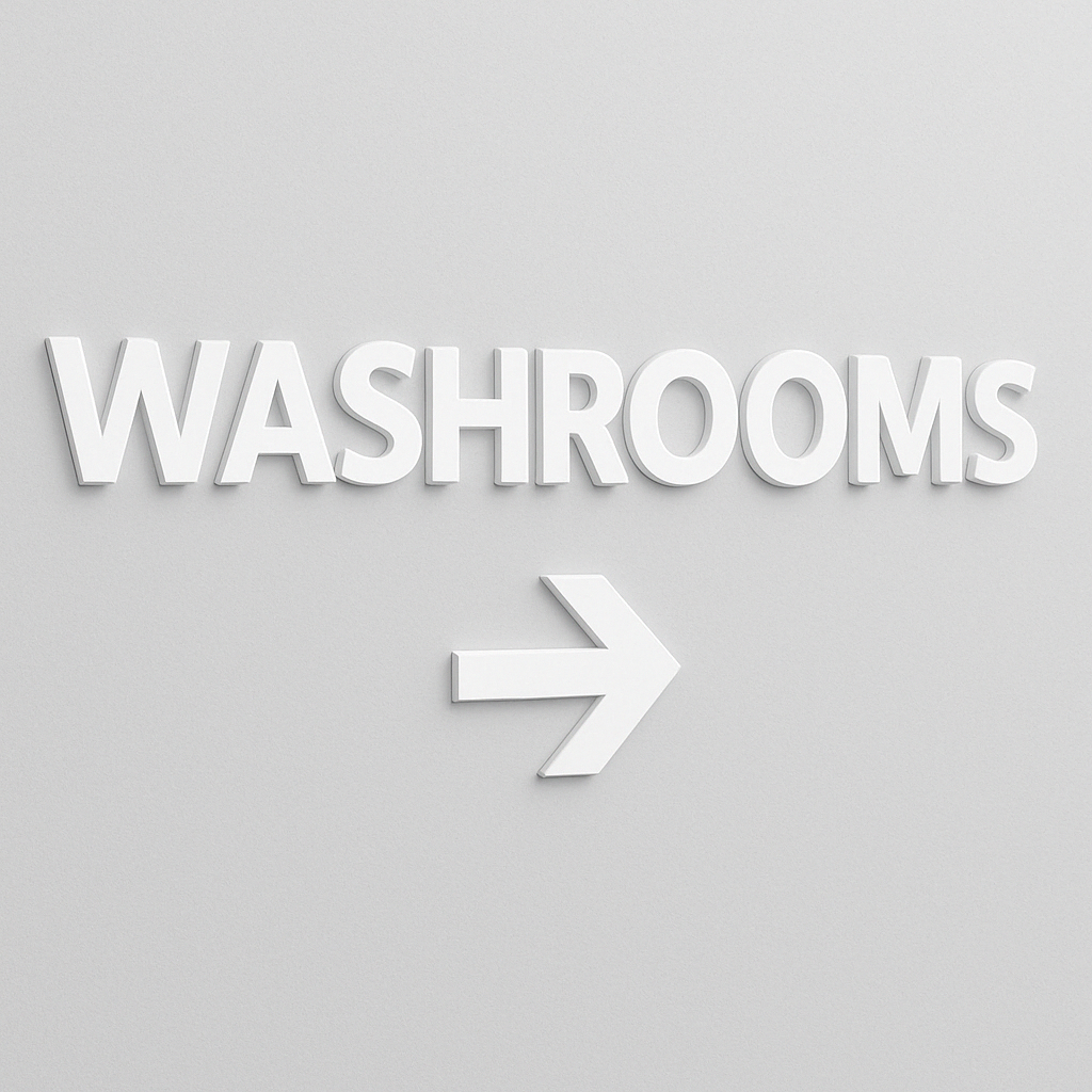 White 0.5 inch thick PVC letters saying WASHROOMS with an arrow.  Letters include an alignment template and double sided hanging tape