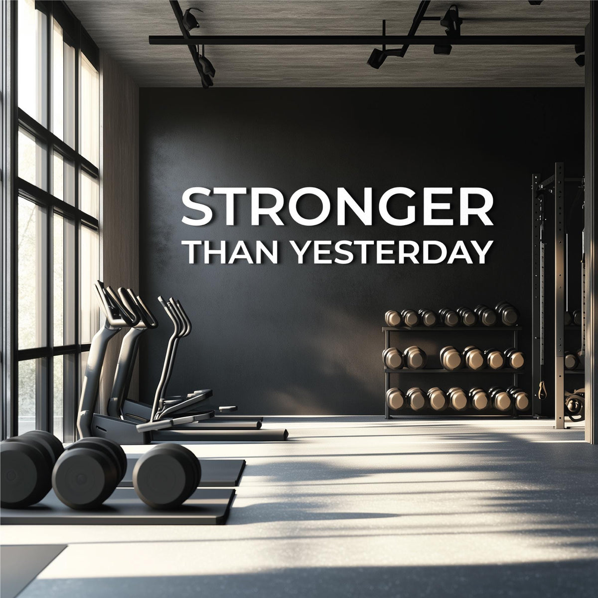 STRONGER THAN YESTERDAY gym wall letters in white PVC 0.5 inch thick installed above dumbbell rack in modern home gym”