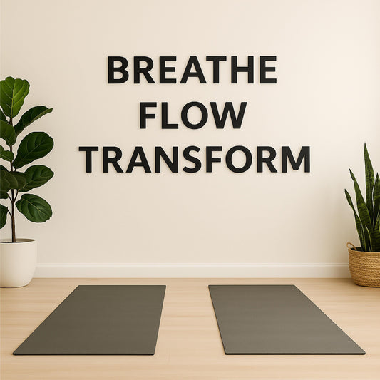 a yoga area with a large sign on the wall saying 'BREATHE FLOW TRANSFORM' in black 3d letters